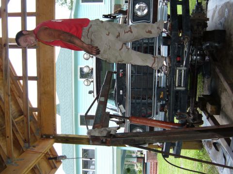 1978 Ford Bronco - A man stands on the front of a 1978 Ford Bronco, which is undergoing some work.