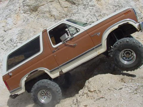 1981 Ford Bronco - This two-tone Ford Bronco is navigating a rocky, off-road terrain.