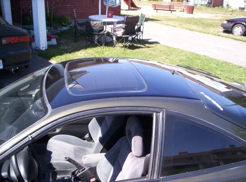 1993 Ford Probe - The interior of a car is visible, a sunroof and gray cloth seats.