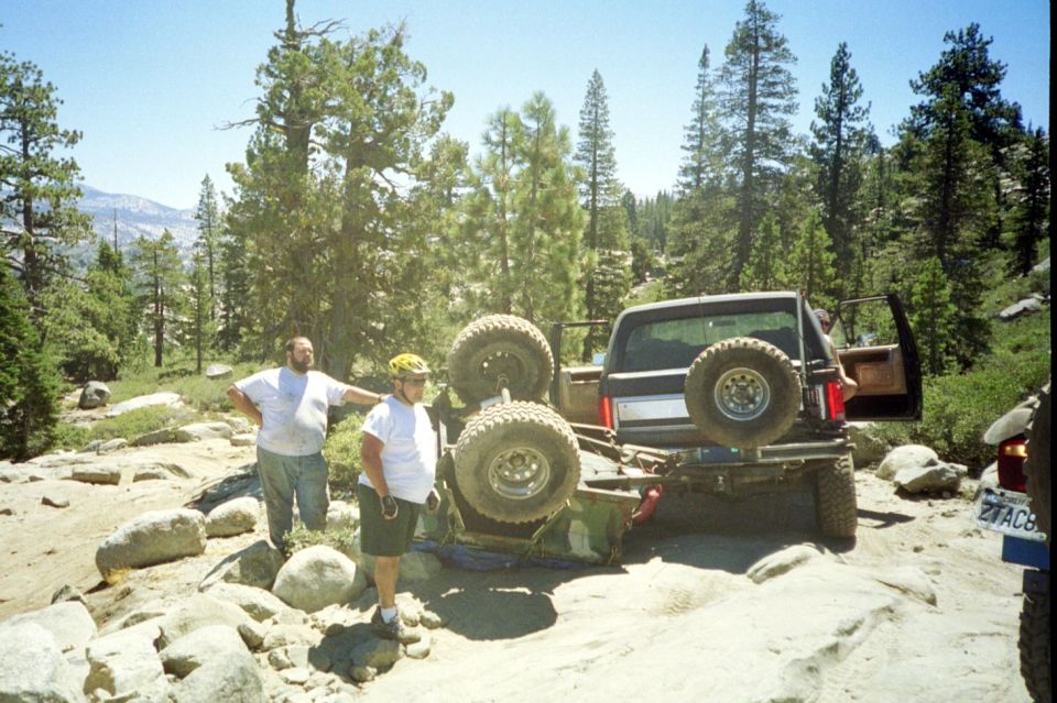 Black off-road SUV stuck on rocks, rear view. License plate ZTAC8