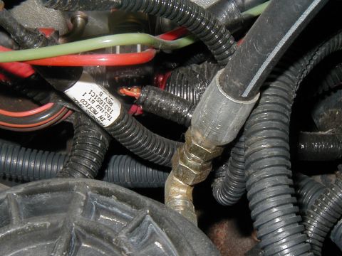 2002 Ford Excursion - Engine wiring harness and hoses with a part number visible on a label.
