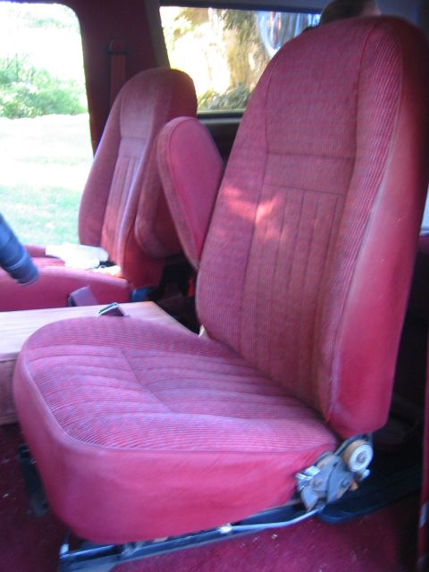 1990 Ford Bronco - Interior view of red fabric car seats, possibly from a 1990 Ford Bronco.