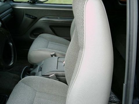 1992 Ford Bronco - Interior view of a vehicle's front seats and center console, showing the fabric pattern and console details.