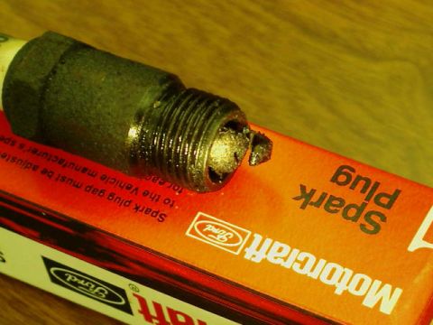 1992 Ford Bronco - Close-up of a used Motorcraft spark plug on its original packaging.