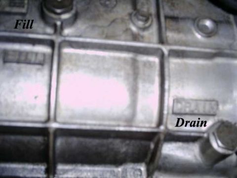 1992 Ford Bronco - Close-up view of a vehicle's transmission casing, showing the fill and drain points.