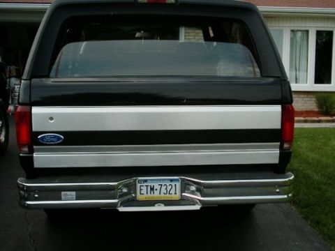 1992 Ford Bronco - The rear of a 1992 Ford Bronco, its distinctive two-tone paint scheme and chrome bumper.