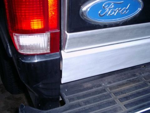 1992 Ford Bronco - Close-up of the rear of a 1992 Ford Bronco, showing the tailgate and Ford emblem.