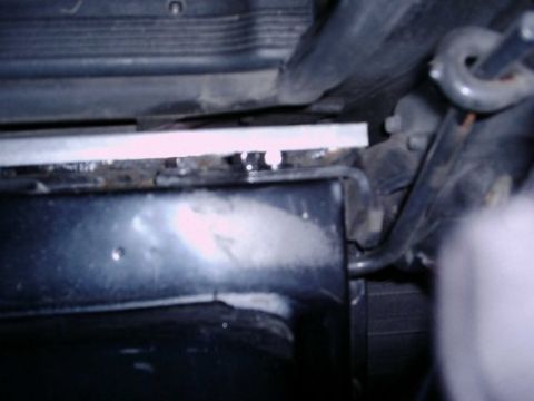 1992 Ford Bronco - Detail of vehicle undercarriage shows corrosion on frame and radiator support.