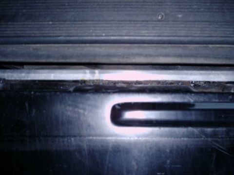 1992 Ford Bronco - Interior view of a vehicle tailgate, focusing on seals and metal structure.