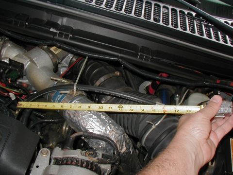2002 Ford Excursion - Measuring intake piping in the engine bay. The tape measure shows approximately 18 inches.