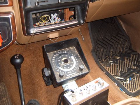 1988 Ford Bronco - The interior of a vehicle shows a CB radio and a dual-range gauge, with wiring visible in the dashboard.