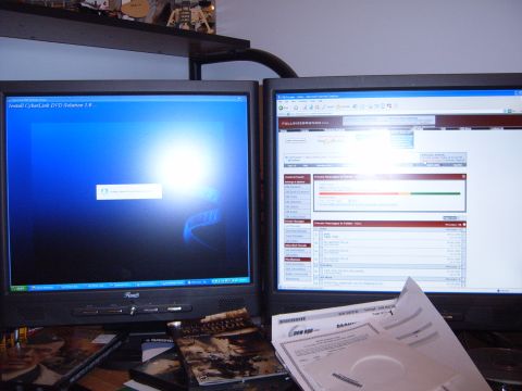 1988 Ford Bronco - A desk setup two computer monitors displaying different applications, surrounded by media and papers.