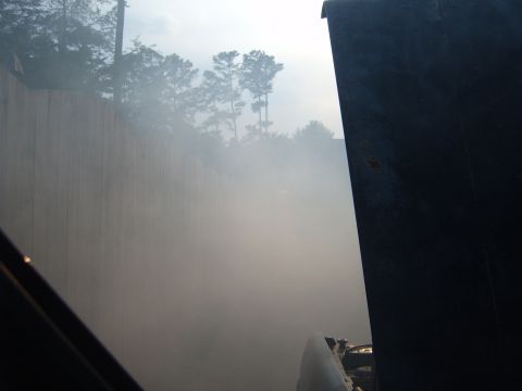 1988 Ford Bronco - Exhaust smoke billows from a dark vehicle, obscuring the background scenery.