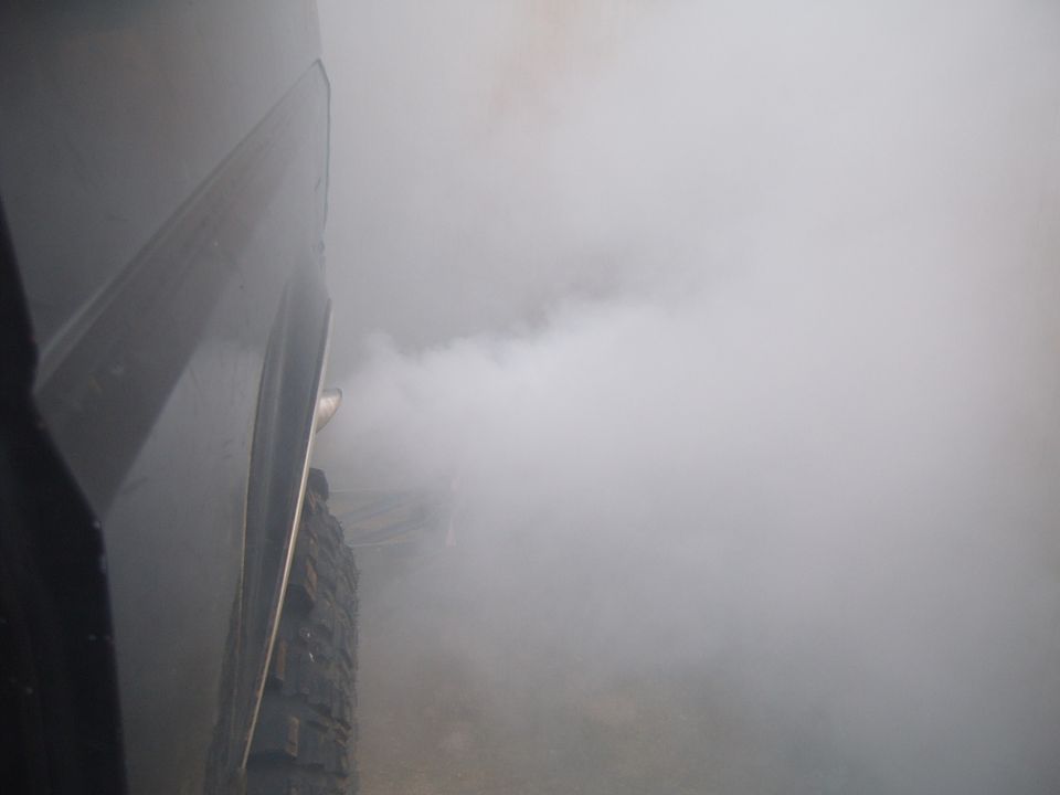 Exhaust smoke billowing from a vehicle's tailpipe