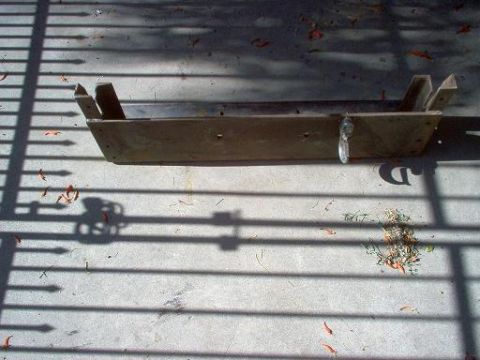 1988 Ford Bronco - A winch bumper mount is shown on a concrete surface, casting shadows from a nearby fence.