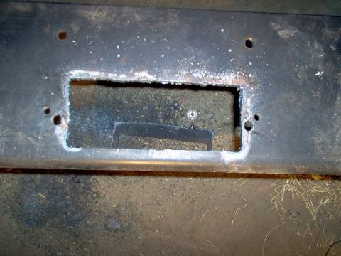 1988 Ford Bronco - A metal plate has been modified with a rectangular opening, likely for a component installation.