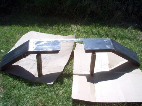 1988 Ford Bronco - A metal bumper part is shown outdoors, resting on cardboard.