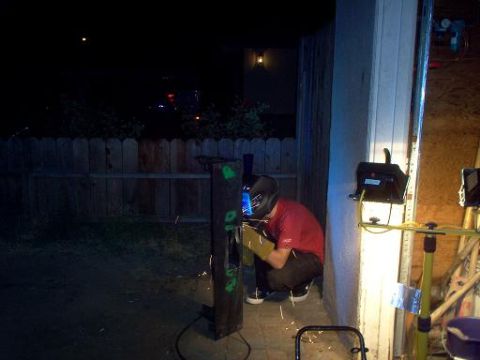 1988 Ford Bronco - A person is welding metal outdoors at night, with sparks flying.