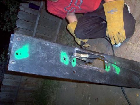 1988 Ford Bronco - Working on a bumper with green spray paint markings.