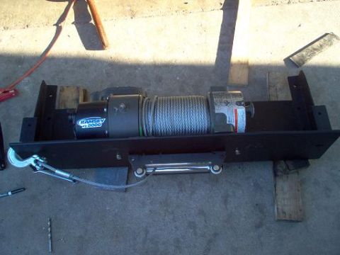 1988 Ford Bronco - Ramsey 8000 winch assembly on a mounting plate, possibly for installation.
