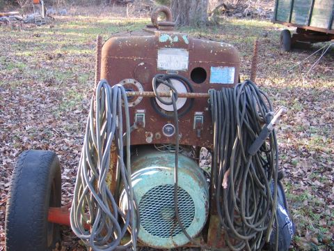 2004 Ford F-150 - A weathered welding machine sits outdoors, with a trailer visible in the background.