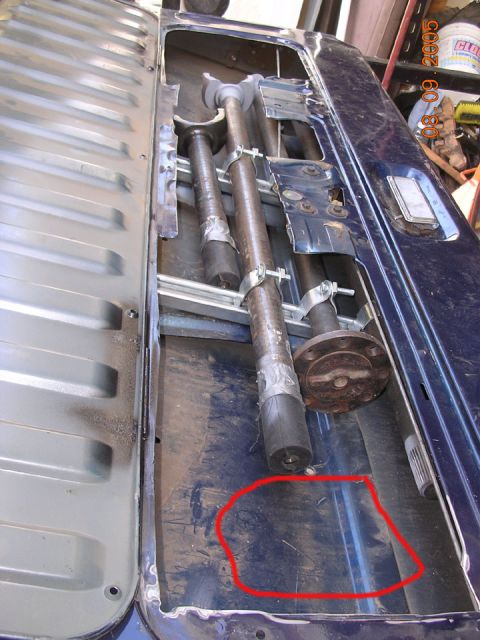 1994 Ford Bronco - secured unistrut to the window motor bracing, and the red circle will be where I mount the spare steering gearbox.