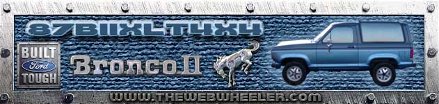 Blue Ford Bronco II with a silver horse emblem and "Built Ford Tough" badge