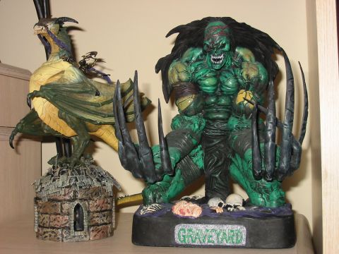 1991 Ford Bronco - Two fantasy figurines, a dragon and a green monster, are displayed together on a shelf.