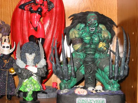 1991 Ford Bronco - A display shelf holds several comic book character figures, including a large green monster with sharp claws and a red-clad female figure.