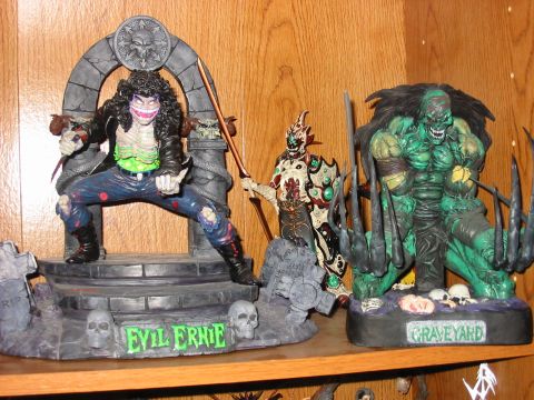 1991 Ford Bronco - Collectible action figures displayed on a shelf, including 'Evil Ernie' and 'Graveyard' figures.