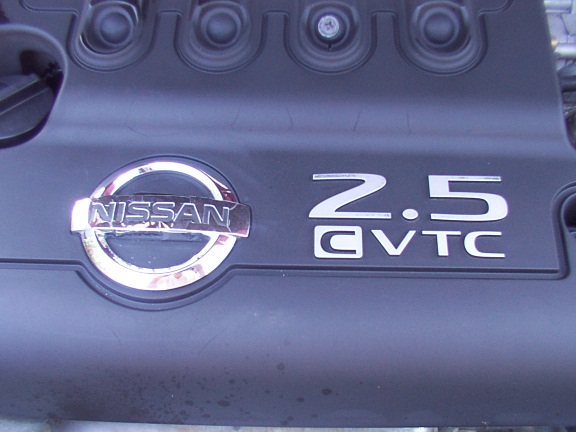 Nissan 2.5 CVTC badging on a black plastic engine cover