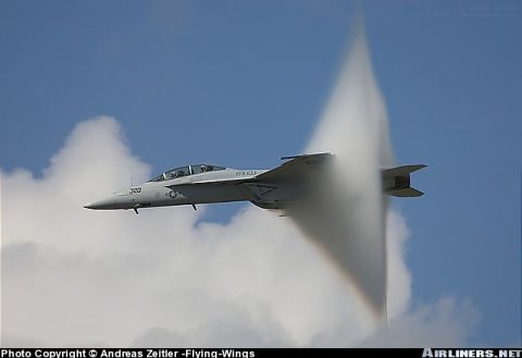 1972 Ford Ranchero - A fighter jet is captured mid-flight, generating a visible vapor cone as it exceeds the speed of sound.