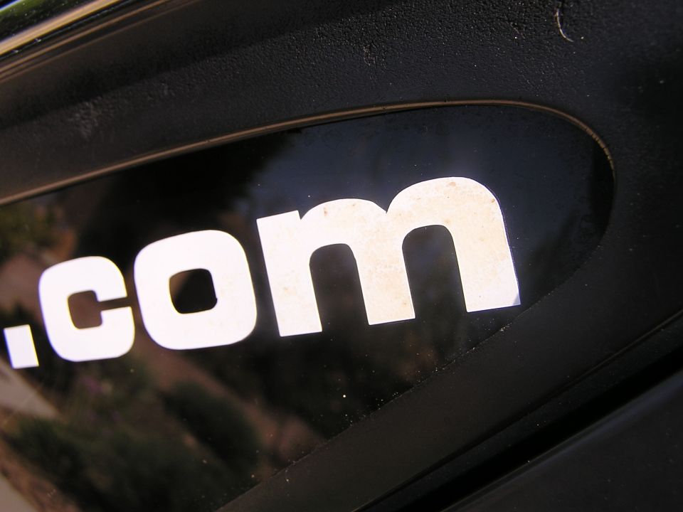 White .com text on a black background, likely a decal