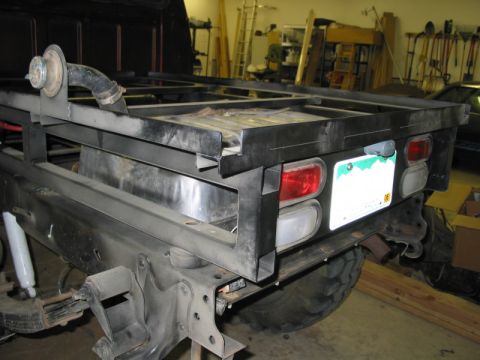 1981 Ford Bronco - Custom flatbed truck chassis with fuel tank and rear lights visible.
