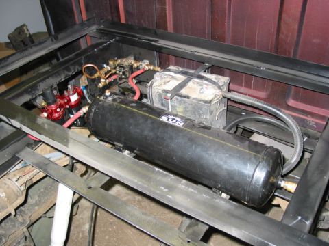 1981 Ford Bronco - Air suspension components, including a tank and solenoids, are installed in the vehicle's frame.