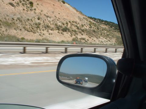 1999 Ford Crown Victoria - Traffic on the highway viewed through the side mirror of a vehicle.