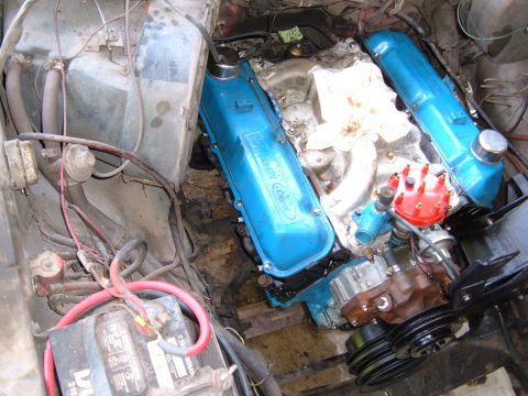 1978 Ford Bronco - Close-up of a V8 engine, likely a Ford, in an engine bay with visible battery and wiring.