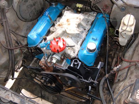 1978 Ford Bronco - Close-up view of a V8 engine with bright blue Ford valve covers and a red distributor cap.