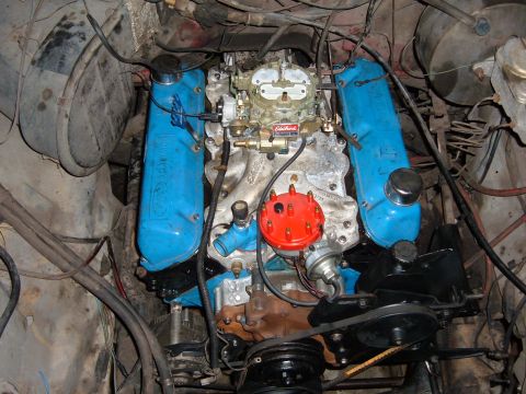 1978 Ford Bronco - Close-up view of a V8 engine, blue valve covers and a prominent carburetor.