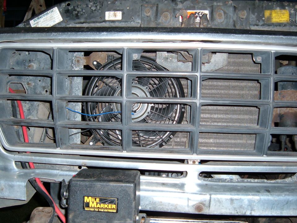 Front grille with electric fan and Mile Marker winch control. No visible year indicators