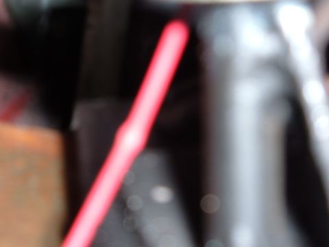 1978 Ford Bronco - A close-up view of a red gauge needle, likely from a vehicle's dashboard, with a website watermark visible.