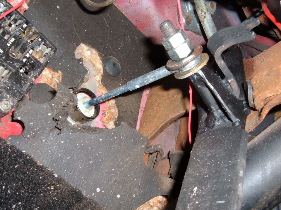 Interior clutch linkage with rust and frayed carpet
