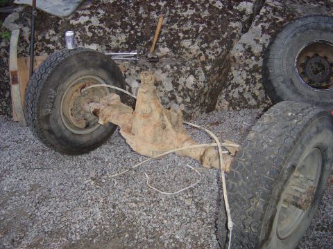 1986 Ford F-150 - This rusty rear axle assembly with tires is a vehicle part, not a complete vehicle.