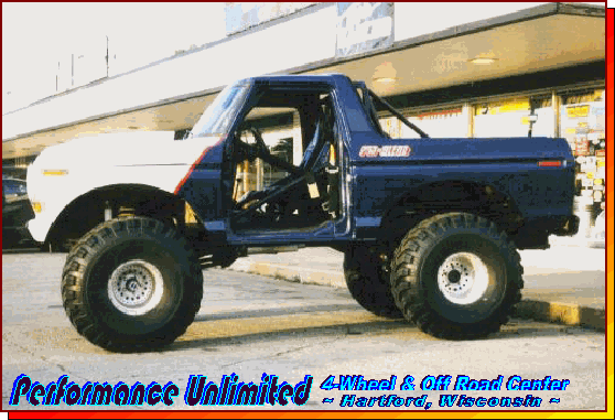 1987 Ford Bronco modified with large tires and lifted suspension, side view
