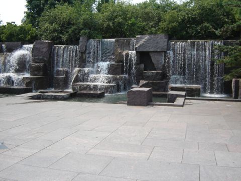 1986 Ford Bronco - A large stone plaza faces a cascading waterfall surrounded by greenery.