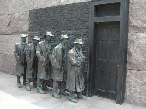 1986 Ford Bronco - Statues depicting men in line outside a building, with text inscribed on the wall.