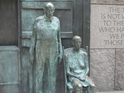 1986 Ford Bronco - Statues depicting a man and woman are seen in front of a stone wall with engraved text.