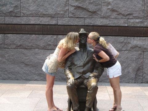 1986 Ford Bronco - Two women kiss a statue in front of a memorial wall.