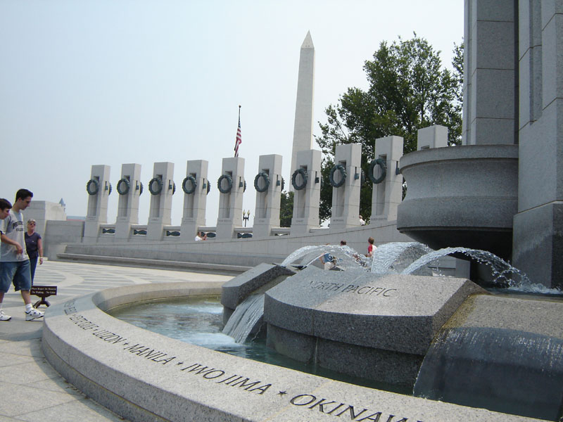 WWII Memorial in DC with fountain and pillars, people walking around