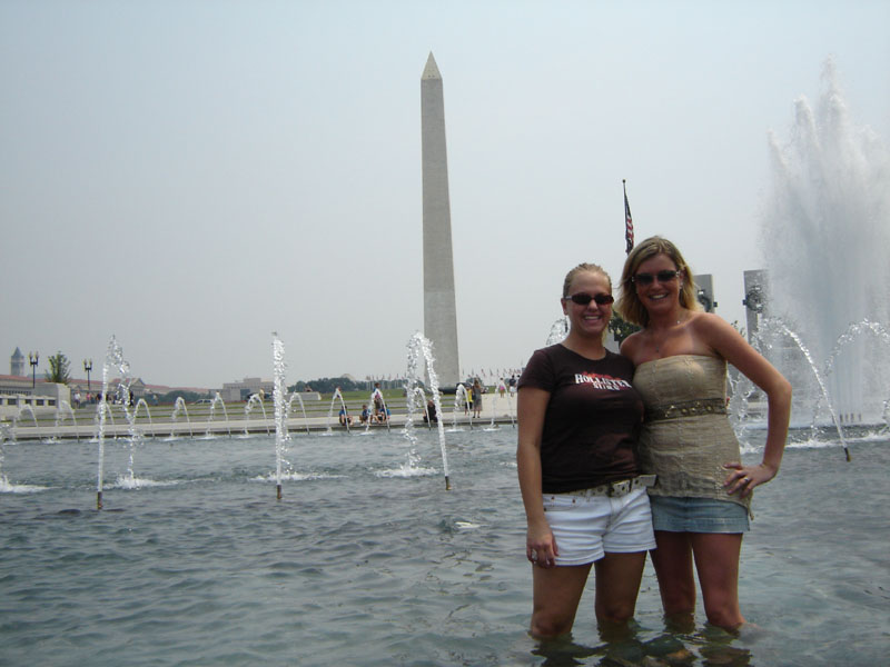 Two women in front of Washington Monument and fountains